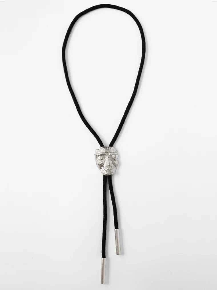 CARVED FACE BOLO TIE